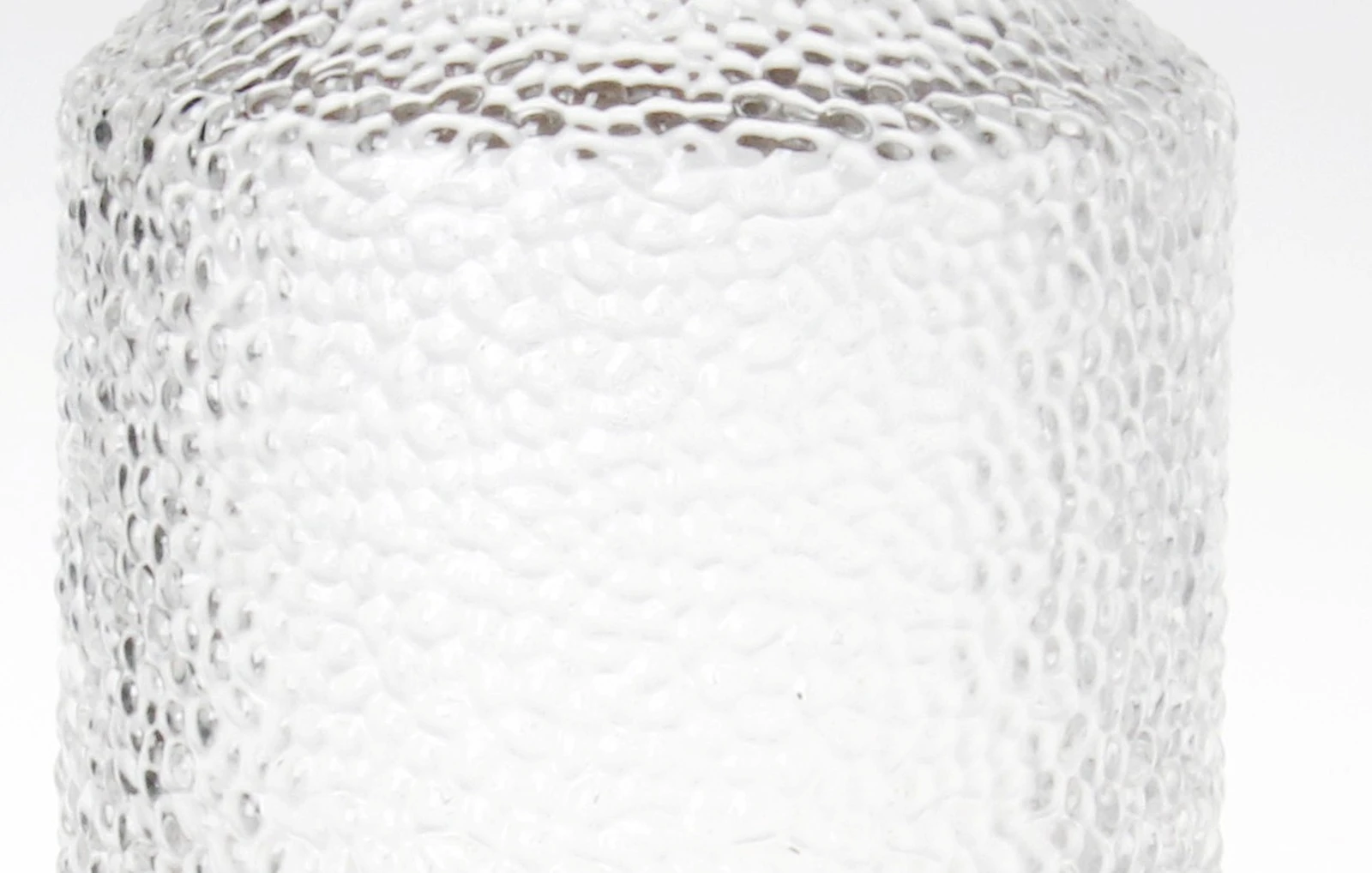 Close view of the hammered dimple texture across the soda-lime glass body Close view of the hammered dimple texture across the soda-lime glass body